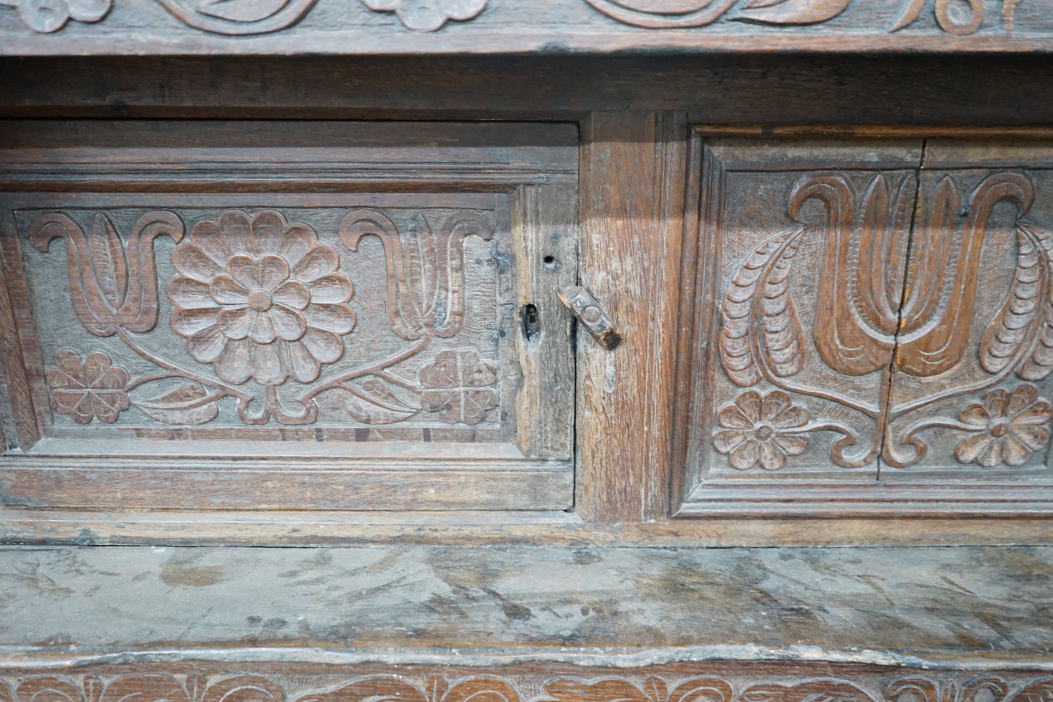 A 17th century carved oak court cupboard, dated 1685, width 170cm, depth 55cm, height 150cm